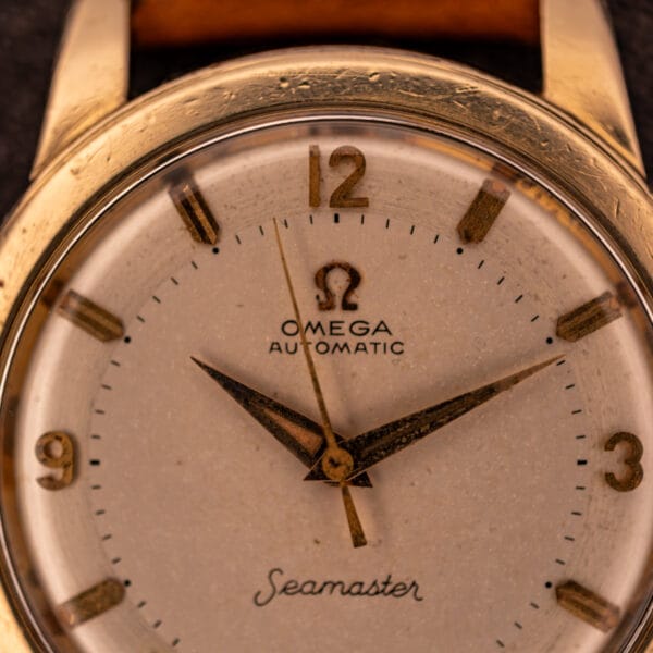 Omega Seamaster GX 6250 dial close-up showing applied Omega logo, printed OMEGA AUTOMATIC text, and gold dauphine hour and minute hands