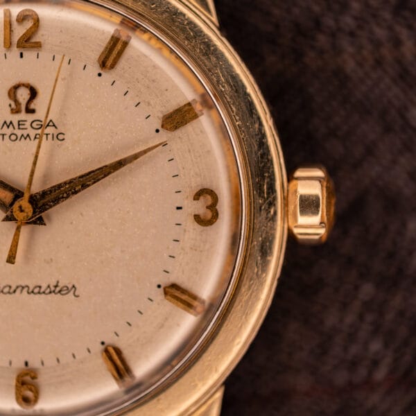 Omega Seamaster GX 6250 right side dial close-up with applied gold 3 numeral and faceted Omega-signed gold crown