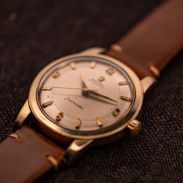 Omega Seamaster GX 6250 three-quarter view on brown leather strap with applied gold dauphine hands centered