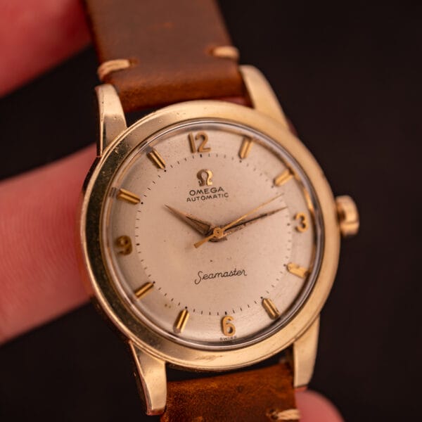 Omega Seamaster GX 6250 dial straight-on view held in hand showing complete factory silver dial composition