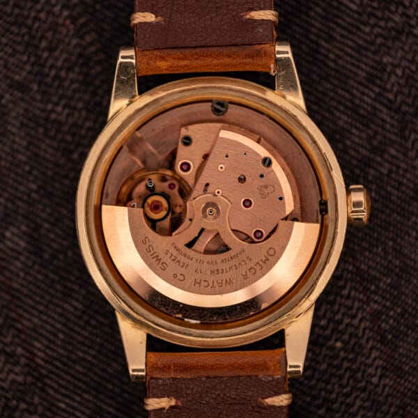 Omega caliber 500 movement with copper-toned full rotor signed OMEGA WATCH Co SWISS, SEVENTEEN 17 JEWELS, ADJUSTED TWO POSITIONS