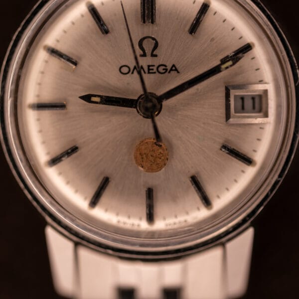 Macro view of Omega Ladymatic 566.002 dial centered on the applied USS United States Steel corporate medallion at 6