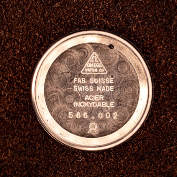 Inner caseback of Omega Ladymatic 566.002 stamped Omega Watch Co triangle, FAB. SUISSE, SWISS MADE, ACIER INOXYDABLE, 566.002