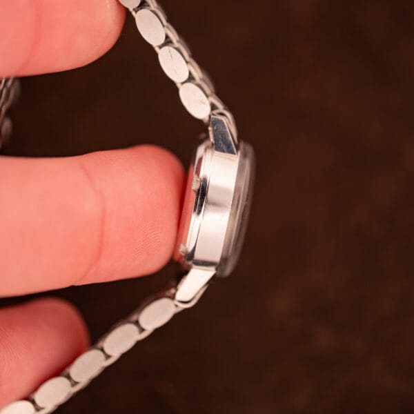 Edge profile of Omega Ladymatic 566.002 stainless steel case showing case flank, lug curve, and acrylic crystal dome