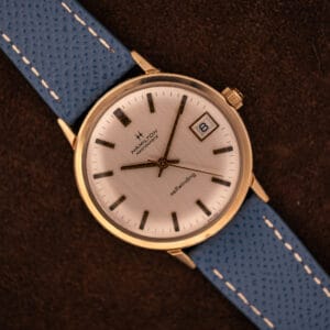 Vintage Hamilton Masterpiece silver sunburst dial top-down with date at three on blue Saffiano leather strap