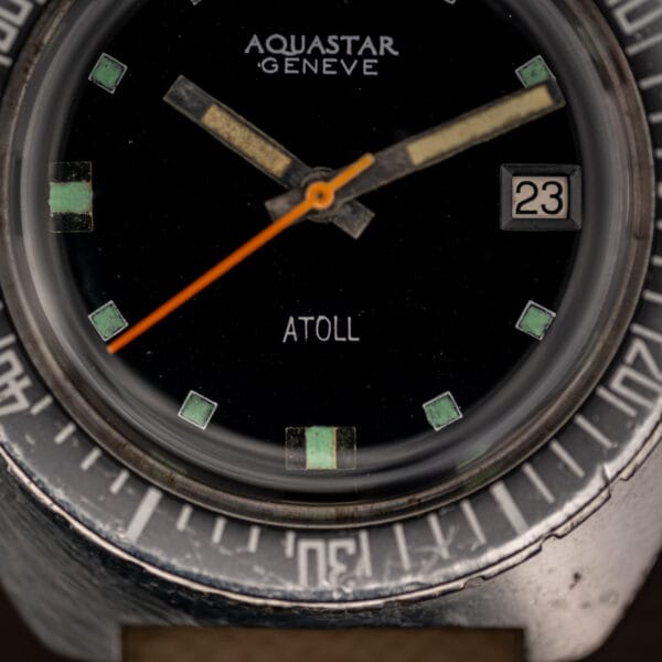 Aquastar Geneve Atoll 1001 dial close-up with white date aperture at three and ATOLL printing above six