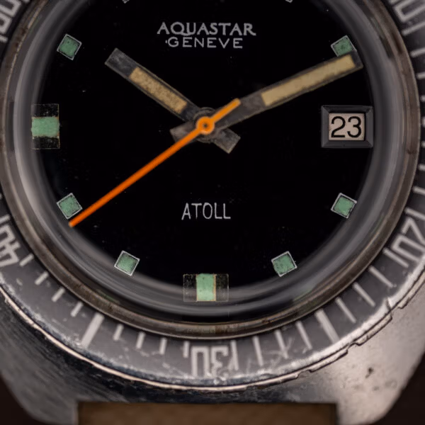 Aquastar Geneve Atoll 1001 dial close-up with white date aperture at three and ATOLL printing above six
