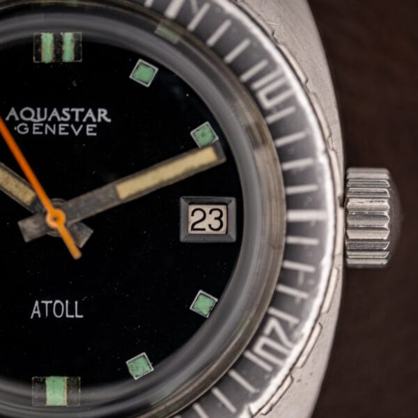 Aquastar Atoll Ref. 1001 dial three-quarter view with fluted crown at three and ghosted dive bezel insert