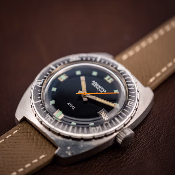 Aquastar Atoll 1001 low three-quarter shot on leather with full bezel countdown markings visible