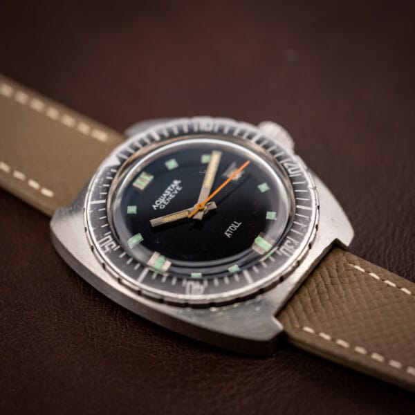 Aquastar Geneve Atoll Ref. 1001 angled dial view showing orange sweep seconds hand and ghosted bezel triangle pip