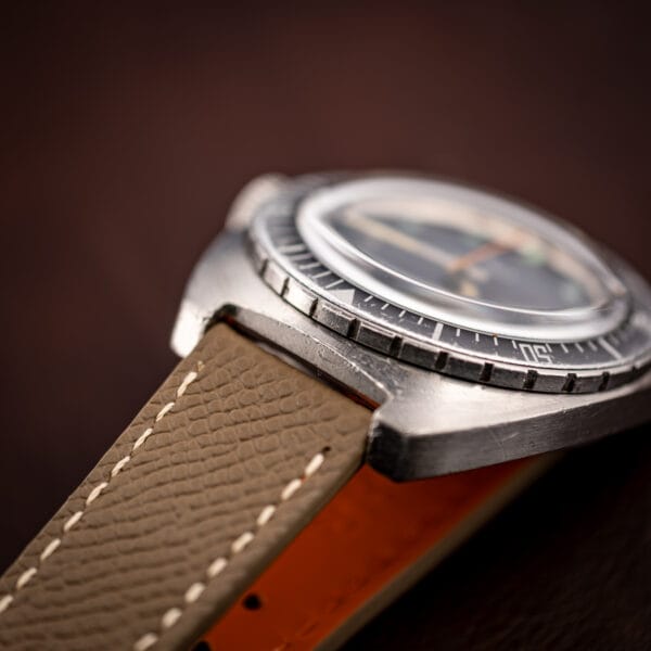 Aquastar Atoll 1001 close three-quarter on leather, dial and ghosted bezel detail