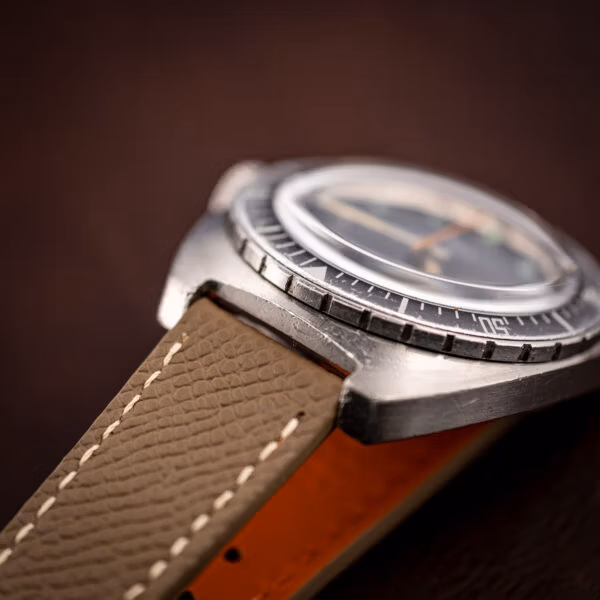 Aquastar Atoll 1001 close three-quarter on leather, dial and ghosted bezel detail