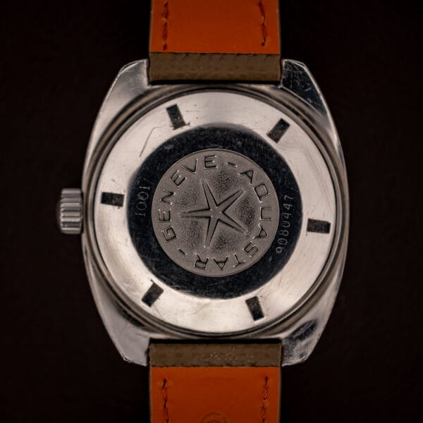 Aquastar Geneve Atoll Ref. 1001 screw-down caseback stamped GENEVE AQUASTAR around five-point compass star medallion, reference 1001 and serial 9080447
