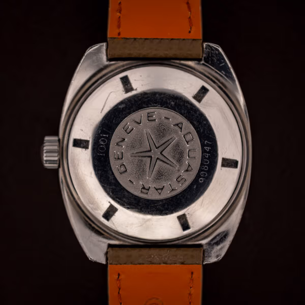 Aquastar Geneve Atoll Ref. 1001 screw-down caseback stamped GENEVE AQUASTAR around five-point compass star medallion, reference 1001 and serial 9080447