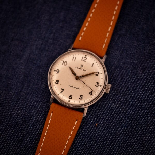Hamilton Accumatic A-507 three-quarter view on tan saffiano leather strap with white contrast stitching