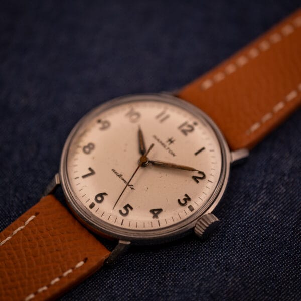Hamilton Accumatic A-507 three-quarter close-up of dial texture, dauphine hands, and Hamilton-signed crown