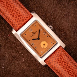 Baume & Mercier Hampton MV045063 polished stainless tank case with copper salmon dial on signed brown lizard leather strap, overhead view