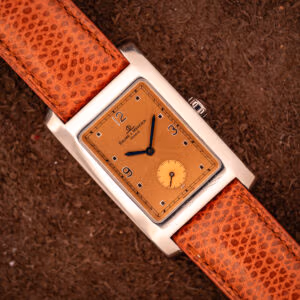 Baume & Mercier Hampton MV045063 polished stainless tank case with copper salmon dial on signed brown lizard leather strap, overhead view