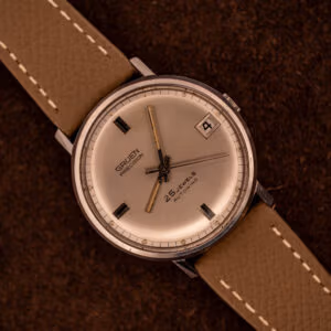Vintage Gruen Precision Autowind on mud grey Saffiano leather strap with silver sunburst dial and date at three