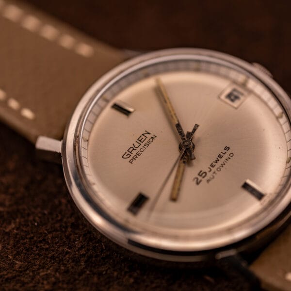 Gruen Precision silver sunburst dial closer angle showing dauphine handset with aged honey lume channels