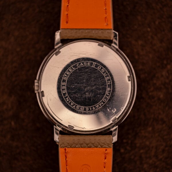 Gruen Precision outer caseback stamped STAINLESS STEEL CASE GRUEN AUTOMATIC around the perimeter