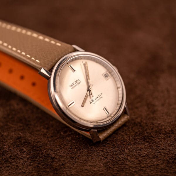 Gruen Precision Autowind hero angle on mud grey Saffiano strap with date at three and sweep seconds