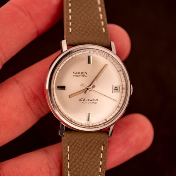 Vintage Gruen Precision Autowind wrist shot on mud grey Saffiano strap showing 34.5mm case proportions