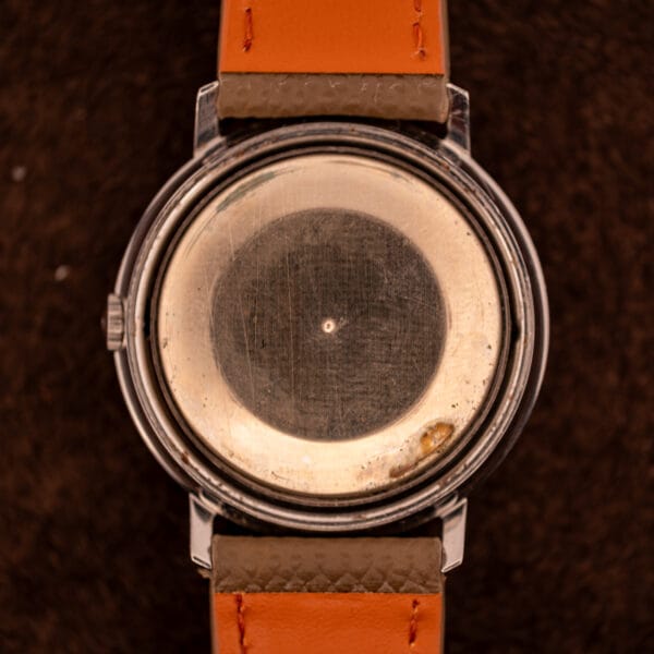 Gruen Precision caseback interior plate showing brushed finish and central pivot mark