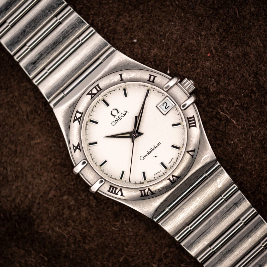 Vintage Omega Constellation 1512.30 Manhattan quartz on suede, full view of cushion stainless steel case and 1552/862 bracelet