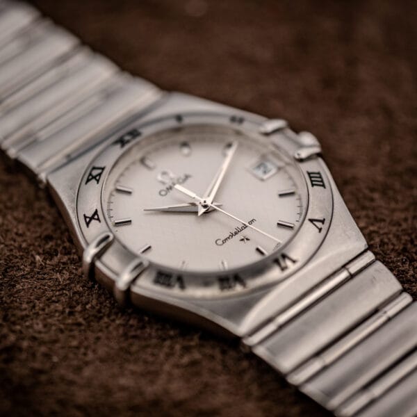 Omega Constellation 1512.30 elevated three-quarter view emphasizing cushion case profile and Roman-numeral bezel detail