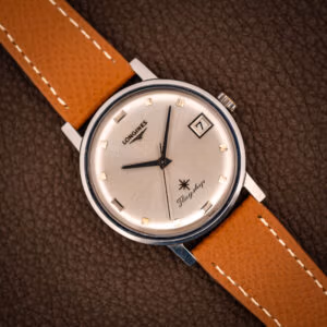 Vintage Longines Flagship Ref. 2821-285 silver sunburst dial with applied gold baton markers, date at three, on tan saffiano leather strap