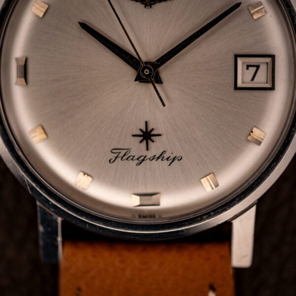 Longines Flagship cursive script and applied five-point star emblem above the SWISS mark at six on the silver sunburst dial