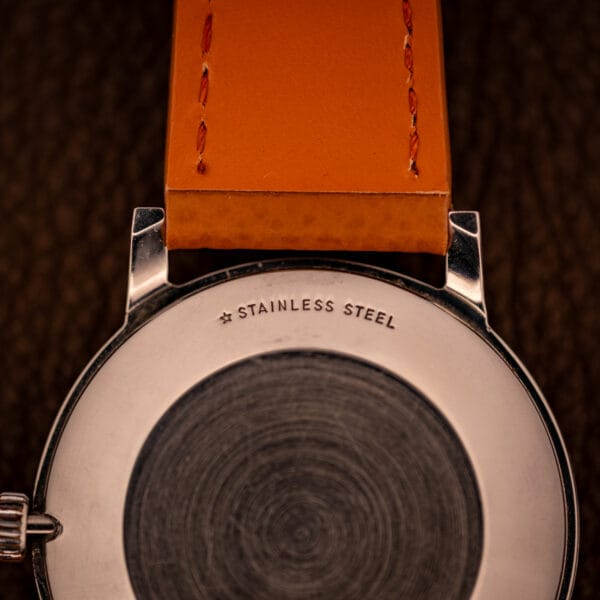 Caseback macro of the Longines Flagship 2821-285 showing the small star case-maker mark beside the STAINLESS STEEL stamping