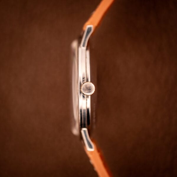 Side profile of the Longines Flagship 2821-285 showing the slim stainless steel midcase and the signed Longines fluted crown