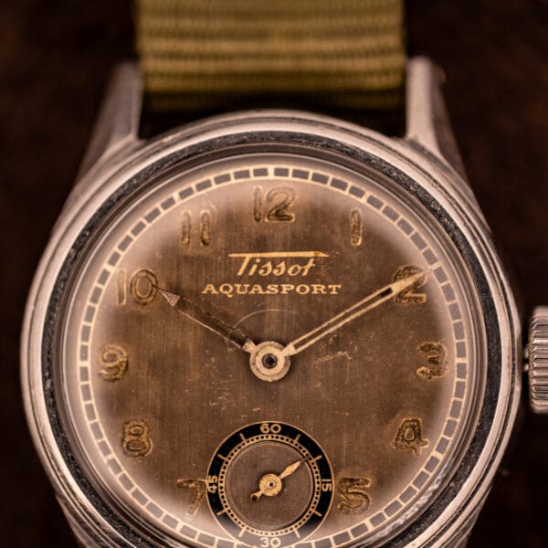 Tissot Aquasport dial detail with sub-seconds register at six, applied gilt Arabic numerals 1 to 12, and original cathedral hands
