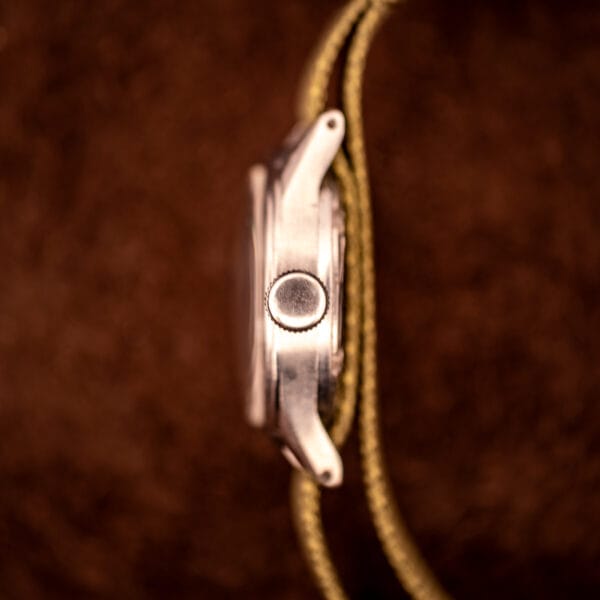 Tissot Aquasport side profile detail of stainless steel case with onion-style winding crown and slim mid-case band