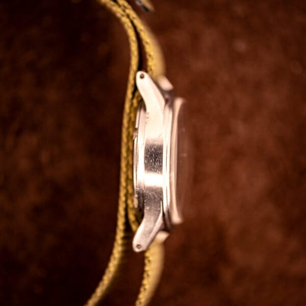 Tissot Aquasport stainless steel case side profile showing downturned faceted lug shape and caseback transition