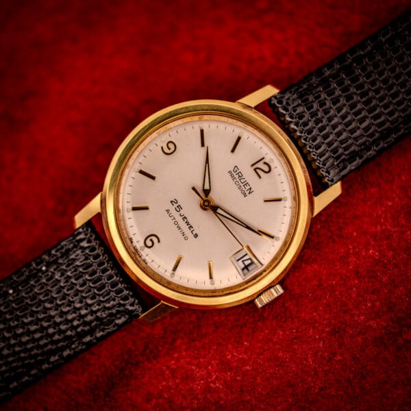 Vintage Gruen Precision macro of dial center, GRUEN PRECISION script, applied gold baton markers, 25 JEWELS AUTOWIND text