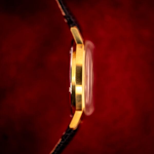 Vintage Gruen Precision case side view, gold-tone lug architecture, polished case band, brushed top surfaces