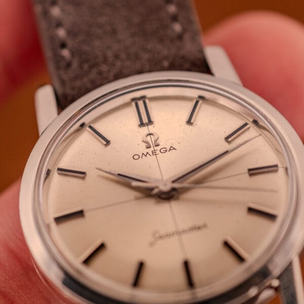Omega Seamaster 135.005 dial macro showing factory cross-hair pattern, dauphine hands, and the sunburst pattern radiating from center