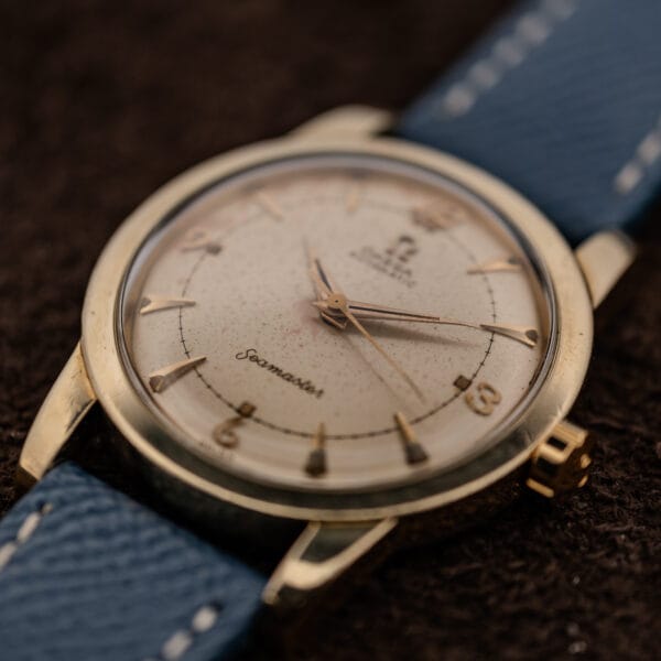 Omega Seamaster bumper 2577-19 angled view showing gold-capped bezel and signed crown at three