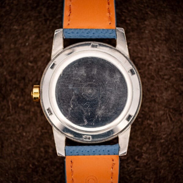 Omega Seamaster 2577-19 stainless steel screw caseback showing concentric turning and honest wear