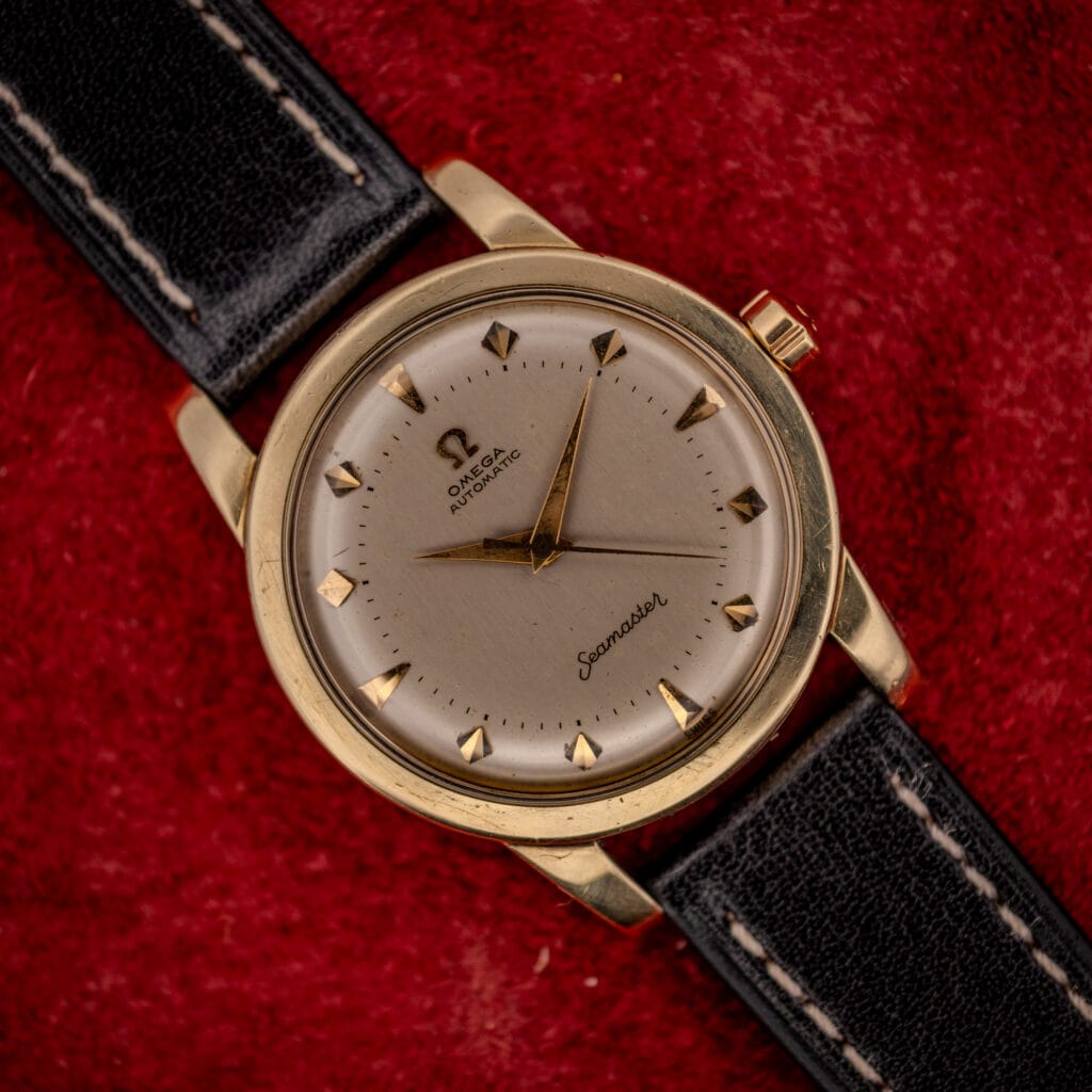 Omega Seamaster bumper ref. 2577-22 gold-capped case with cream two-tier dial, applied dart markers and gold dauphine hands on black leather strap