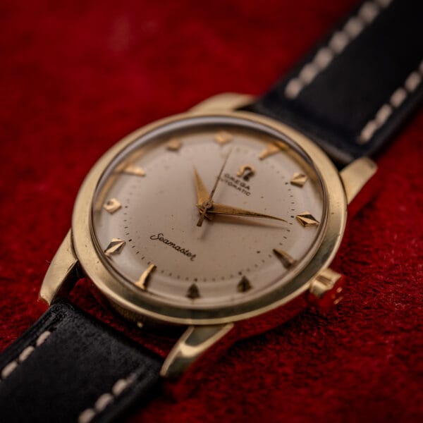 Omega Seamaster 2577-22 gold-capped case at an angle showing domed acrylic crystal and signed Omega crown at three