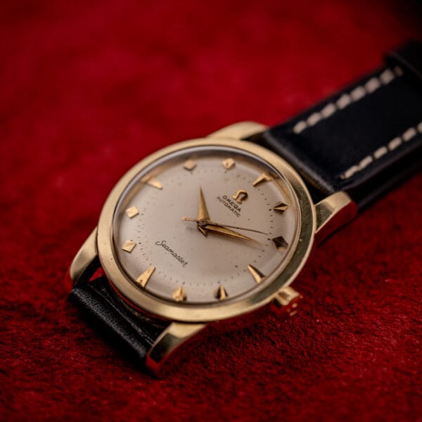 Omega Seamaster ref. 2577-22 on black leather strap with cream stitching, gold-capped case and signed crown