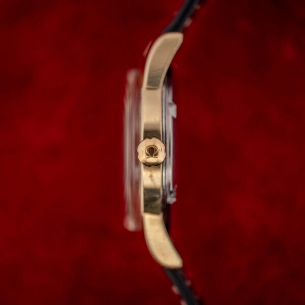 Omega Seamaster signed crown stamped with the Omega symbol, side profile of gold-capped case and domed crystal
