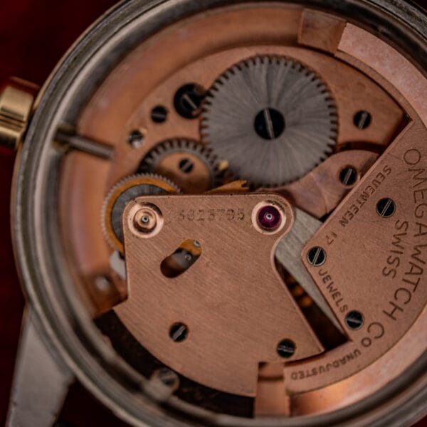Omega caliber 354 movement bridge close-up showing serial 13823795 and SEVENTEEN 17 JEWELS UNADJUSTED stamping