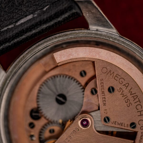 Omega caliber 354 bumper movement detail, going train and OMEGA WATCH Co Swiss bridge signature in copper finish