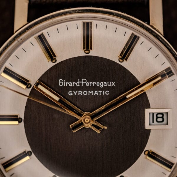 Girard-Perregaux Gyromatic dial close-up showing applied gold baton markers with black centers and the Girard-Perregaux GYROMATIC signature