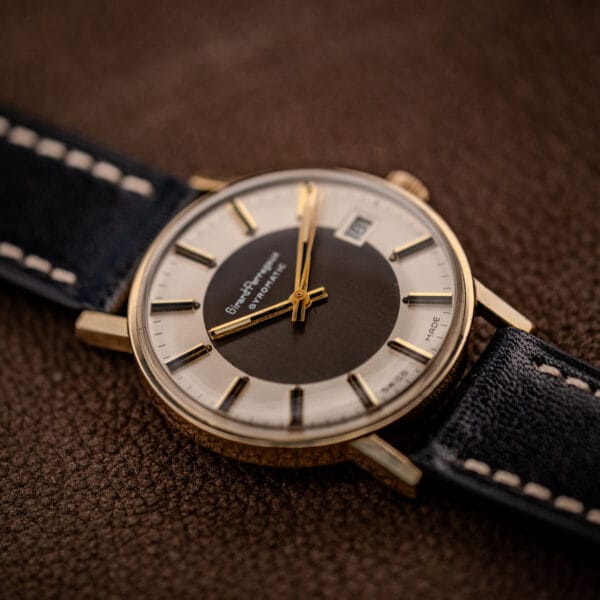 Angled Girard-Perregaux Gyromatic showing the slim gold-filled case profile and dark brushed dial center